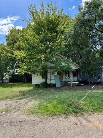 a view of a house with a yard and sitting area