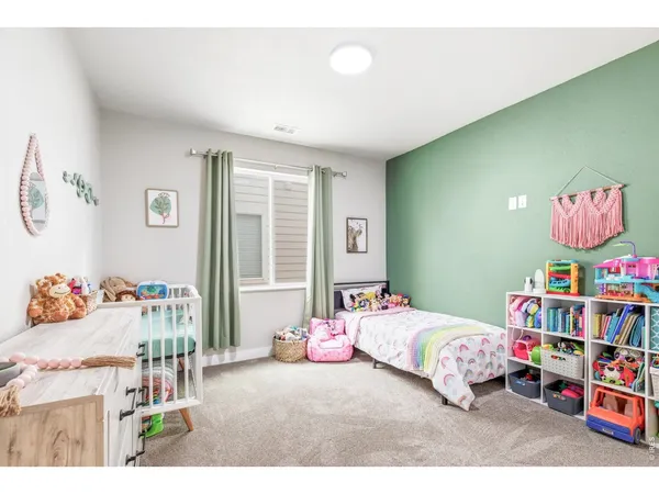 a bedroom with a bed and a painting on the wall