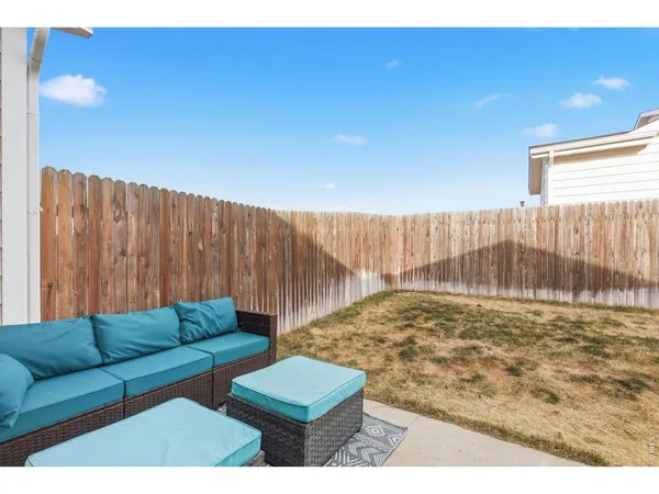 a view of a house with backyard and furniture