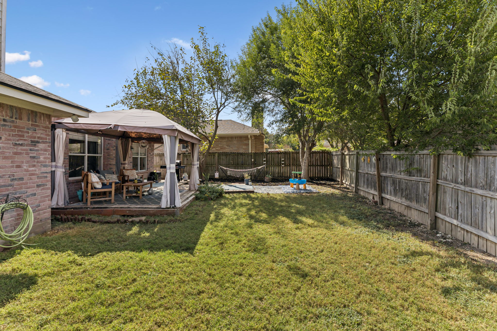 2412 Chestnut Path Round Rock, TX 78664 - Photo 21 of 26 A well-maintained fenced backyard offers a private retreat with a covered patio perfect for relaxation.