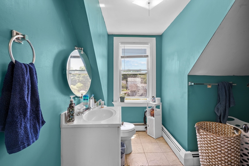 283 Fall River Avenue Seekonk, MA 02771 - Photo 21 of 32 a room with a chair a mirror and a sink