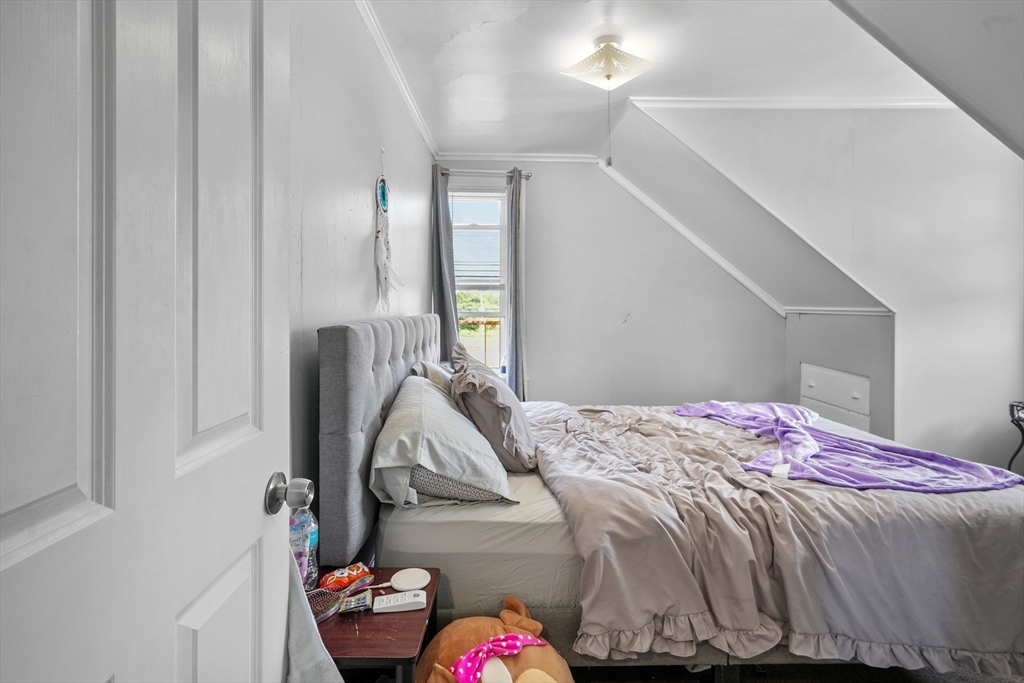 283 Fall River Avenue Seekonk, MA 02771 - Photo 23 of 32 a bedroom with a bed and a chandelier