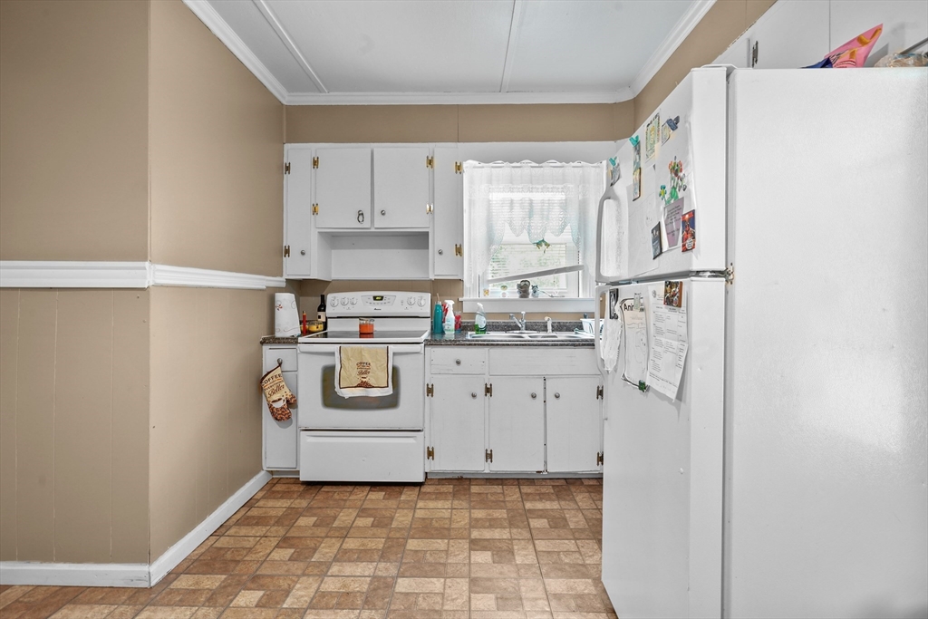 283 Fall River Avenue Seekonk, MA 02771 - Photo 3 of 32 a kitchen with white cabinets and white appliances