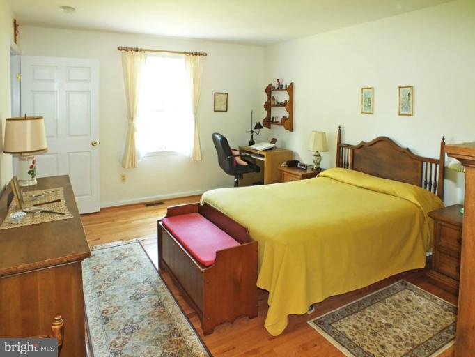 18607 Brick Store Road Hampstead, MD 21074 - Photo 14 of 30 a bed room with two bed and a lamp