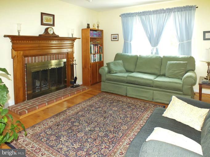 18607 Brick Store Road Hampstead, MD 21074 - Photo 4 of 30 a living room with furniture and a fireplace