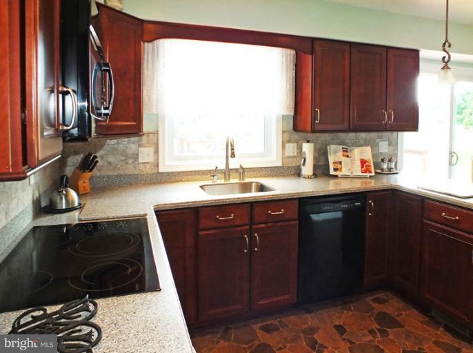 18607 Brick Store Road Hampstead, MD 21074 - Photo 9 of 30 a kitchen with a sink a window and appliances