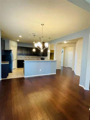 a view of a kitchen with a sink and a fireplace
