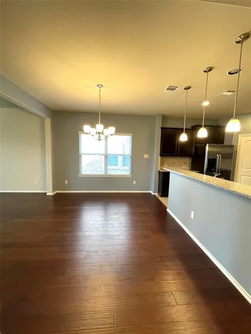 a view of a room with window and wooden floor
