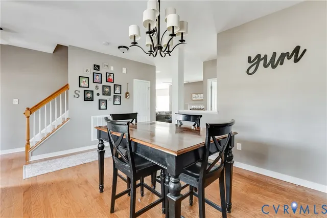 a view of a dining room with furniture and a chandelier