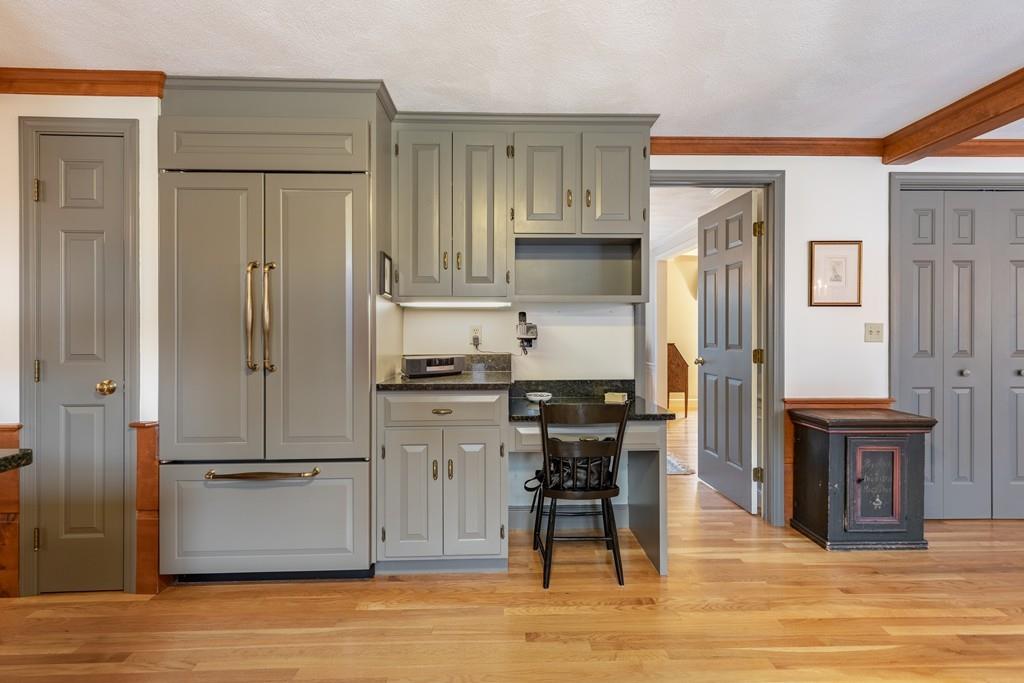 19 Townsend Farm Road Boxford, MA 01921 - Photo 7 of 36 a kitchen with kitchen island granite countertop a refrigerator cabinets and wooden floor