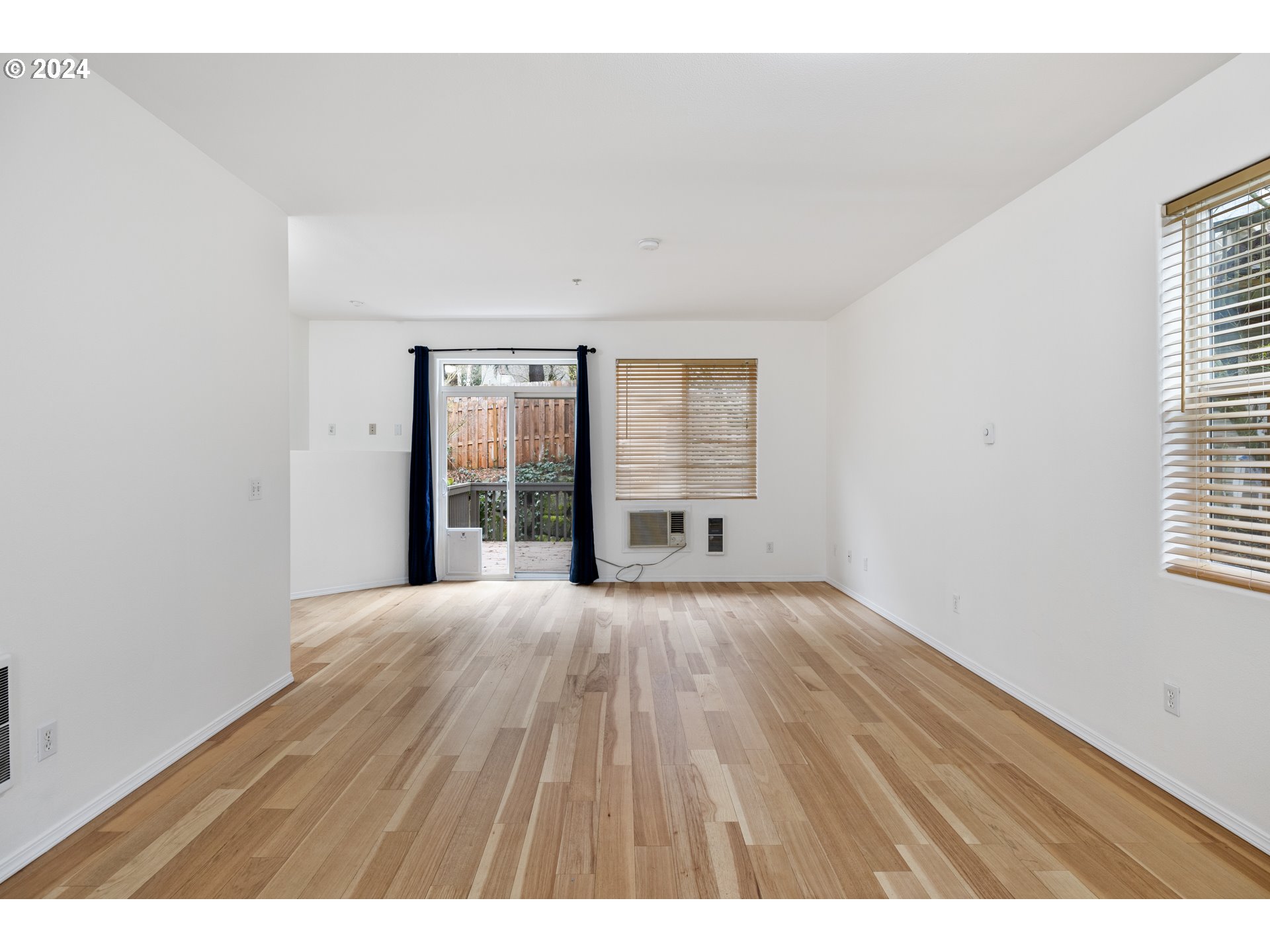 14340 Southwest Cougar Ridge Drive Beaverton, OR 97008 - Photo 12 of 37 a view of an empty room with a window and wooden floor