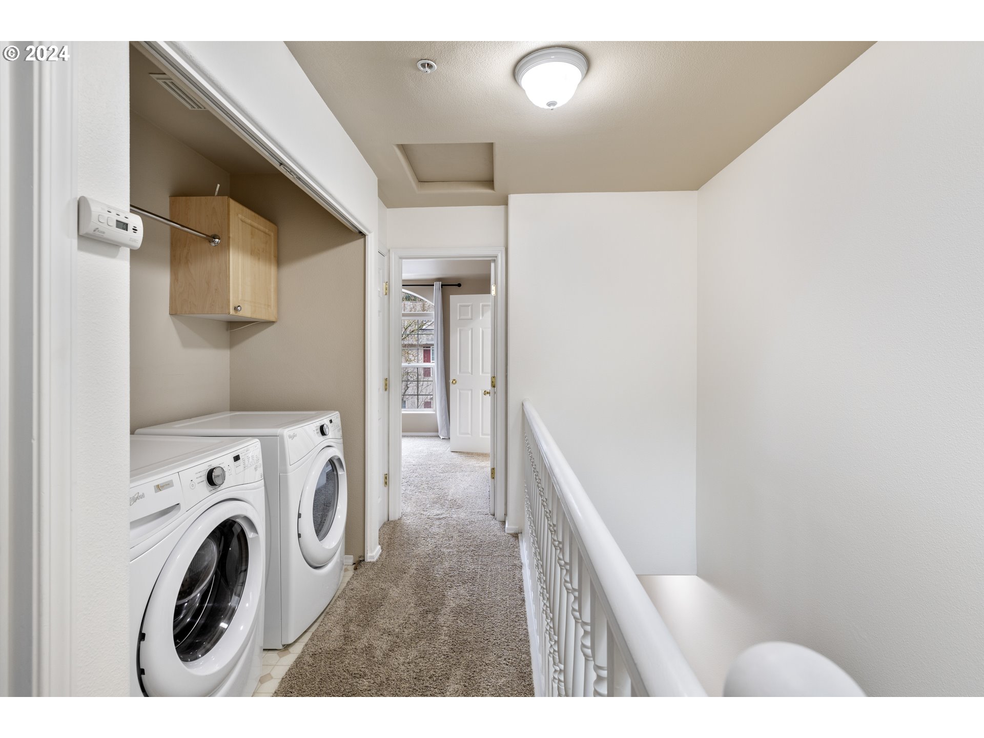 14340 Southwest Cougar Ridge Drive Beaverton, OR 97008 - Photo 17 of 37 a view of a hallway with washer and dryer