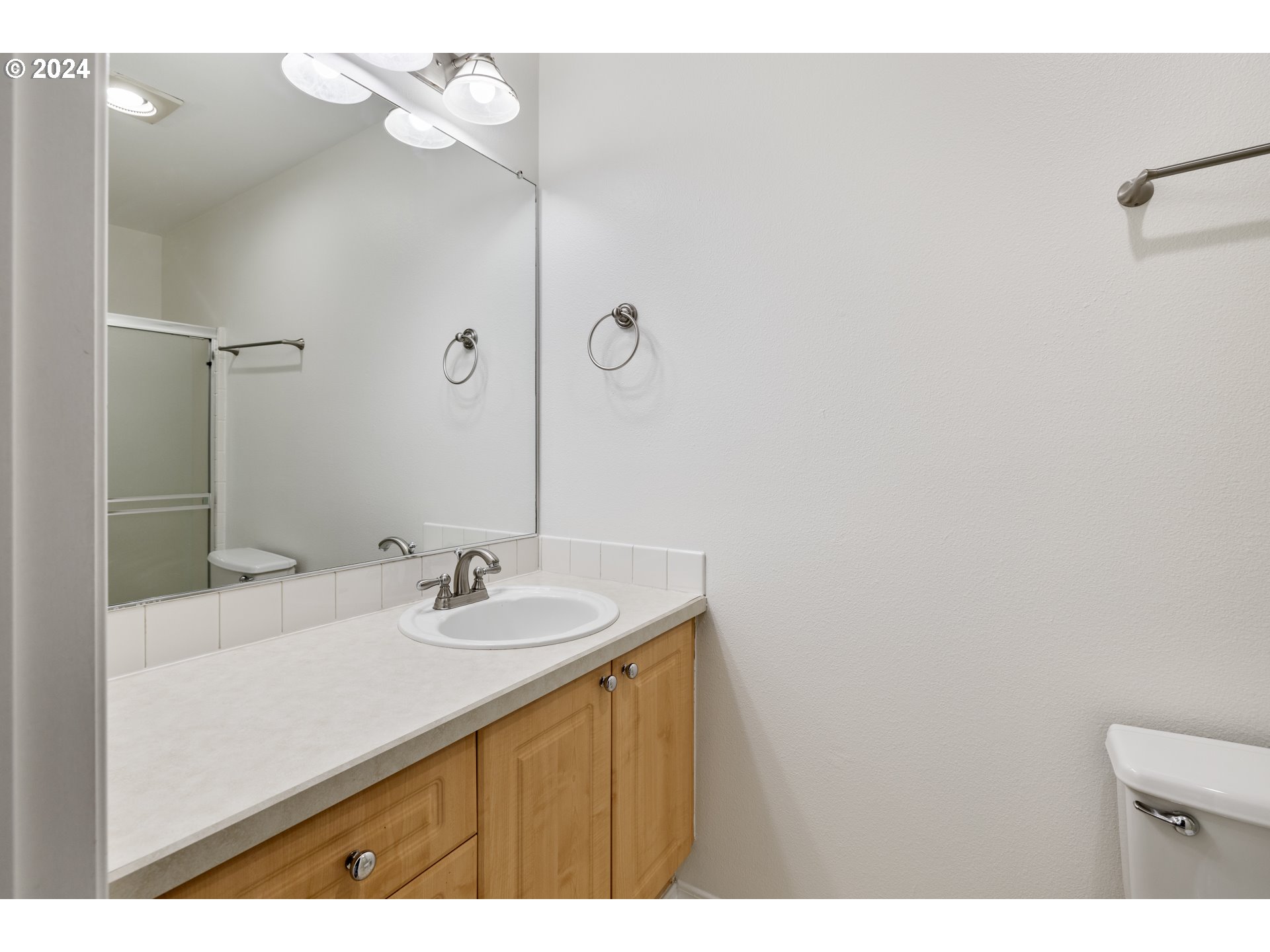 14340 Southwest Cougar Ridge Drive Beaverton, OR 97008 - Photo 21 of 37 a bathroom with a sink a mirror and a vanity