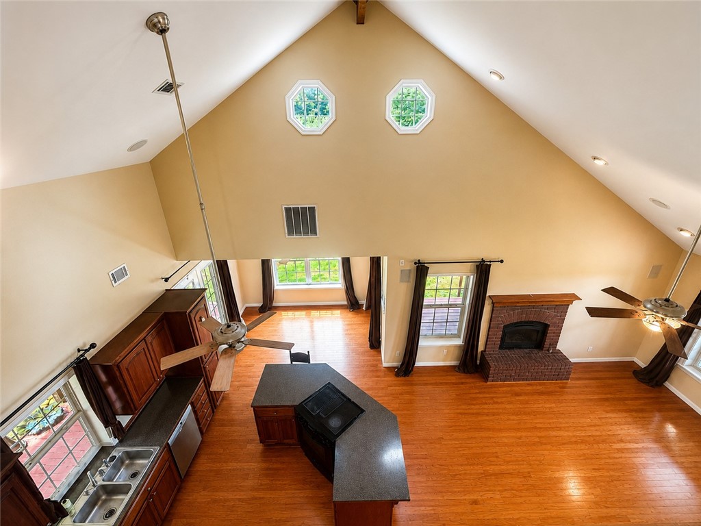 684 Private 2479 Road Clarksville, AR 72830 - Photo 13 of 25 Vaulted ceilings with recessed lighting, two octagon windows, and wood-finish flooring