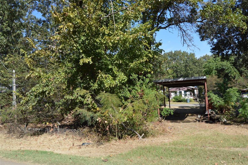 7704 Private Road 7704 Road, Unit 7704 Emory, TX 75440 - Photo 9 of 20 a front view of a house with a yard and garage