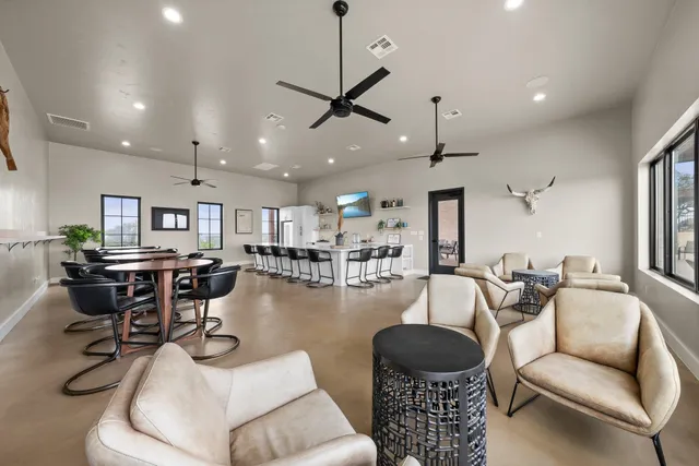 a large white kitchen with granite countertop a white stove top oven and sink