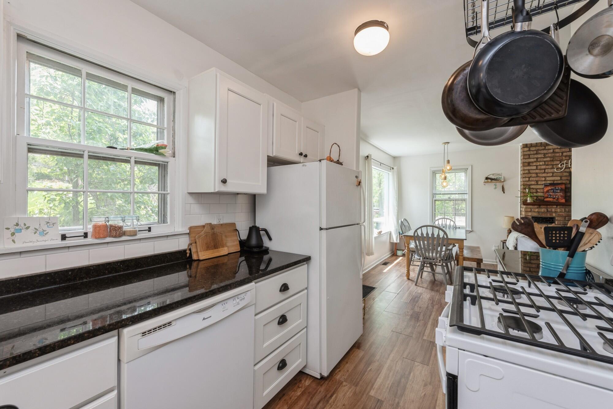 8 Turret Road Portage, IN 46368 - Photo 9 of 36 a kitchen with a stove a refrigerator a stove and a wooden floors