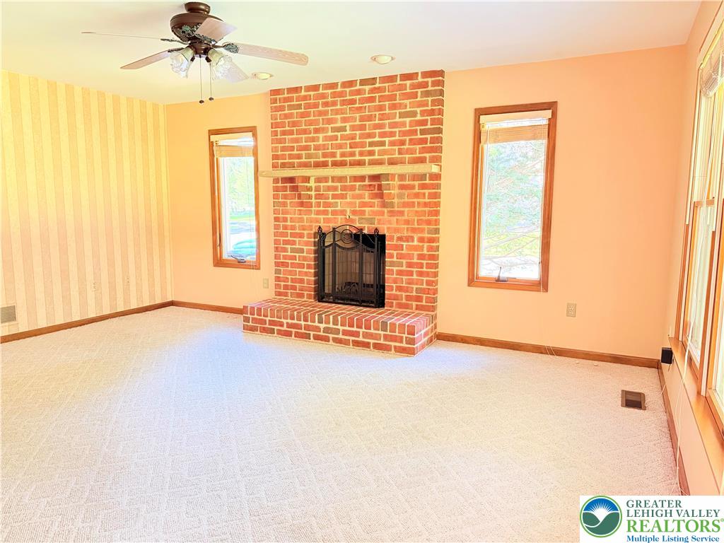 4165 Alder Road Bethlehem, PA 18020 - Photo 14 of 42 en empty room with windows and fireplace