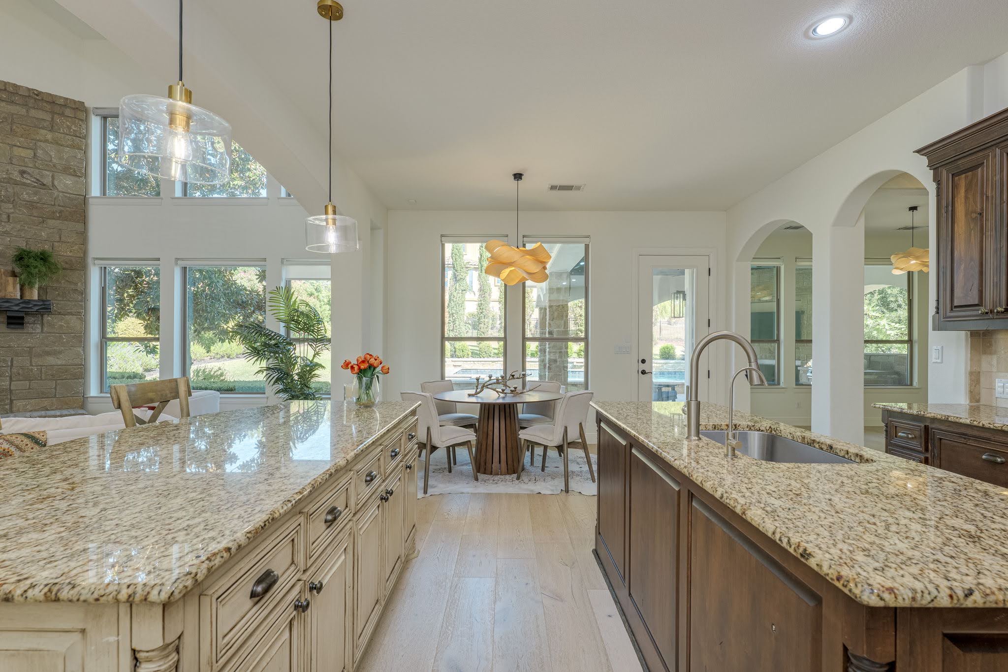 11612 Shoreview Overlook Austin, TX 78732 - Photo 17 of 40 Gleaming granite countertops pair beautifully with rich wood cabinetry in an airy kitchen.