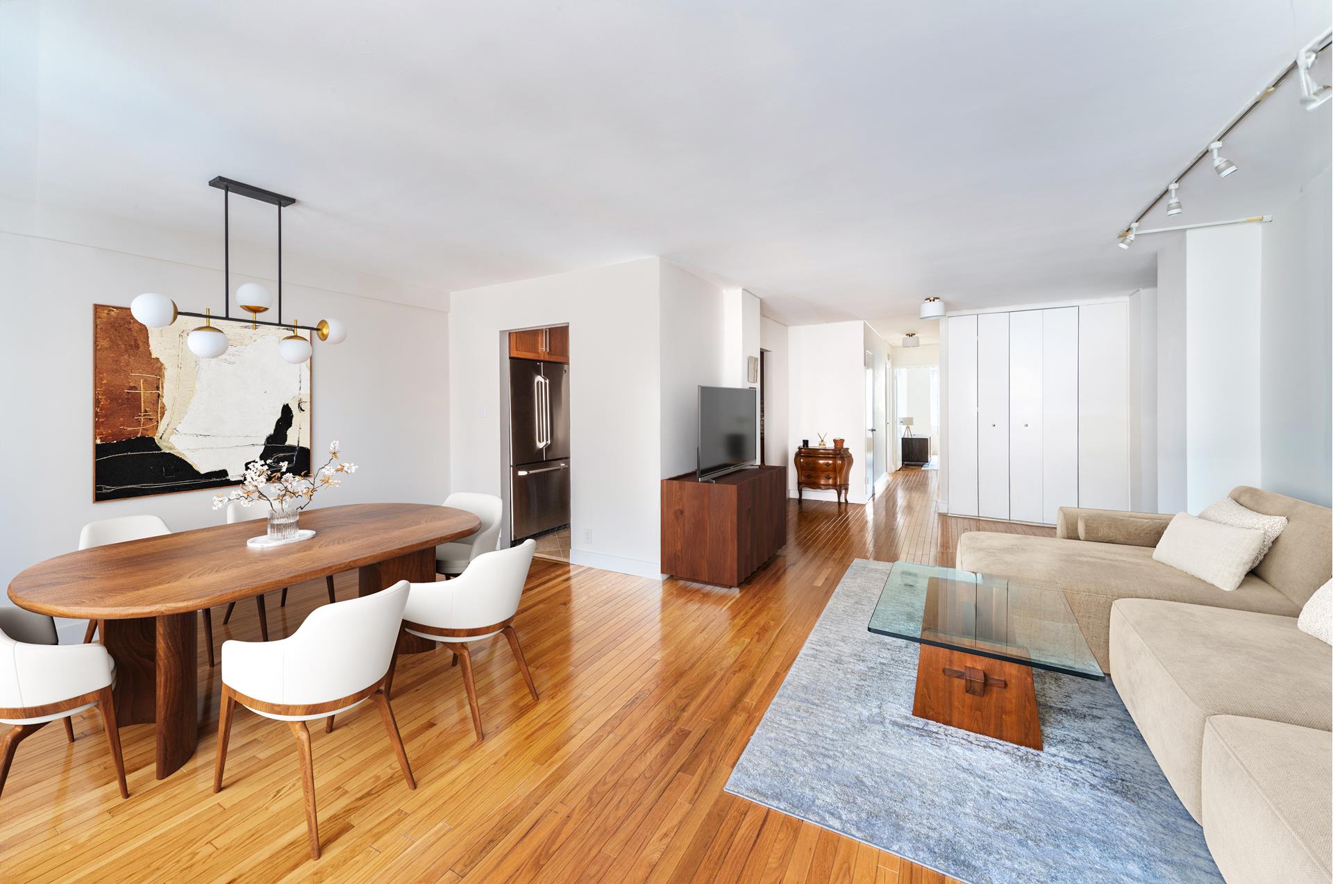201 East 25th Street, Unit 12H Manhattan, NY 10010 - Photo 4 of 8 a living room with furniture and a wooden floor