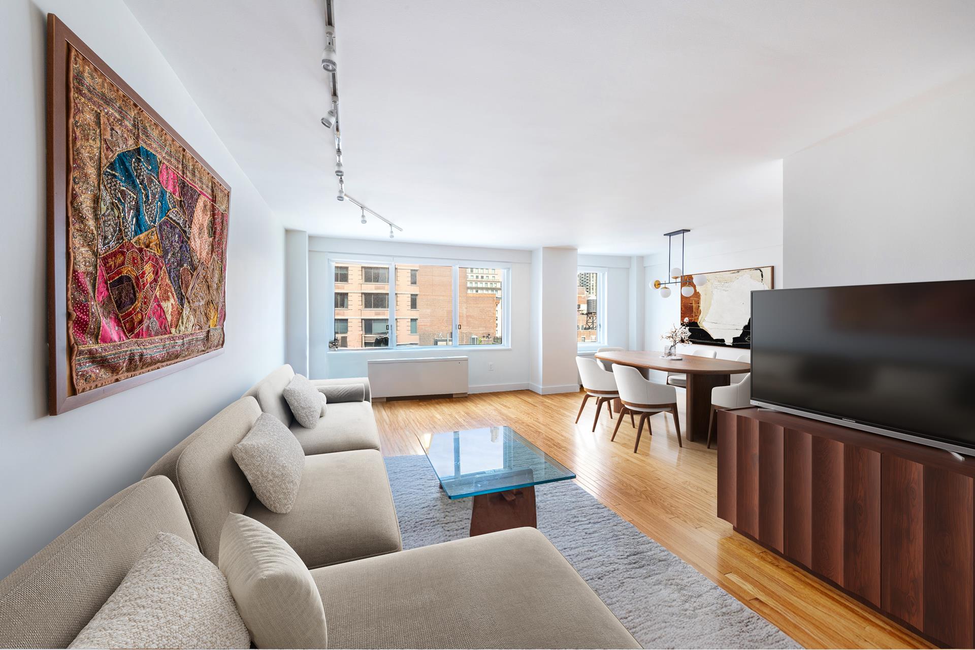 201 East 25th Street, Unit 12H Manhattan, NY 10010 - Photo 5 of 8 a living room with furniture a dining table and a piano