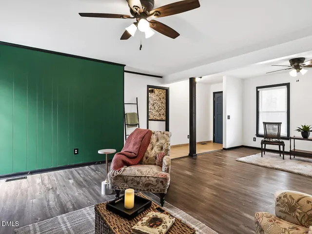 a living room with furniture and a wooden floor