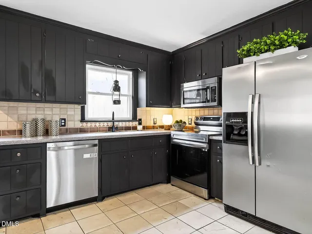 a kitchen with granite countertop stainless steel appliances and a refrigerator