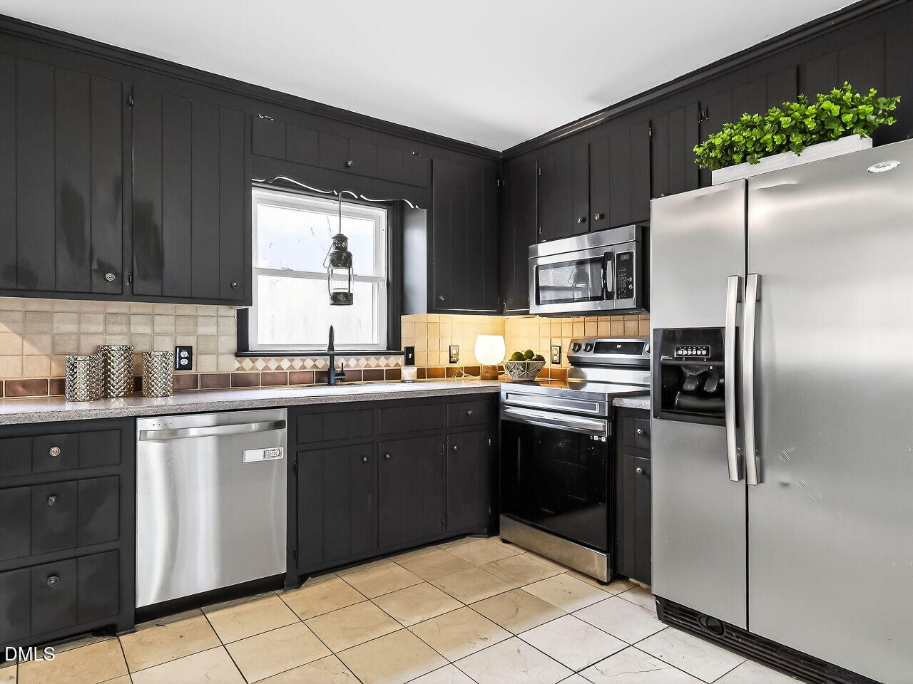 3113 Wild Forest Road Sanford, NC 27330 - Photo 15 of 32 a kitchen with granite countertop stainless steel appliances and a refrigerator