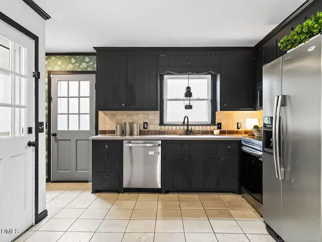 a kitchen with granite countertop a refrigerator and a sink