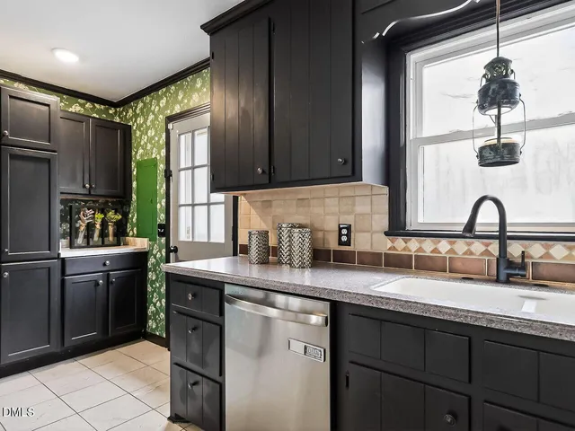 a kitchen with sink a window and cabinets