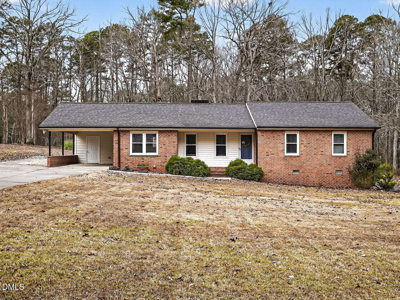 3113 Wild Forest Road Sanford, NC 27330 - Photo 2 of 32 a front view of a house with a garden