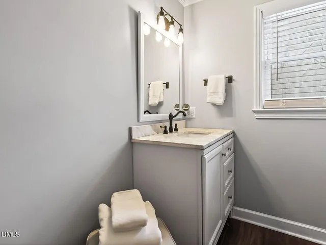 a bathroom with a sink vanity and a mirror