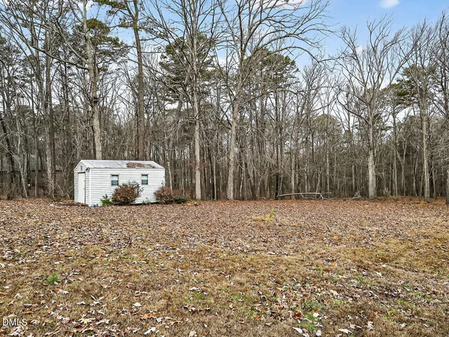 a wooden house with trees in front of it