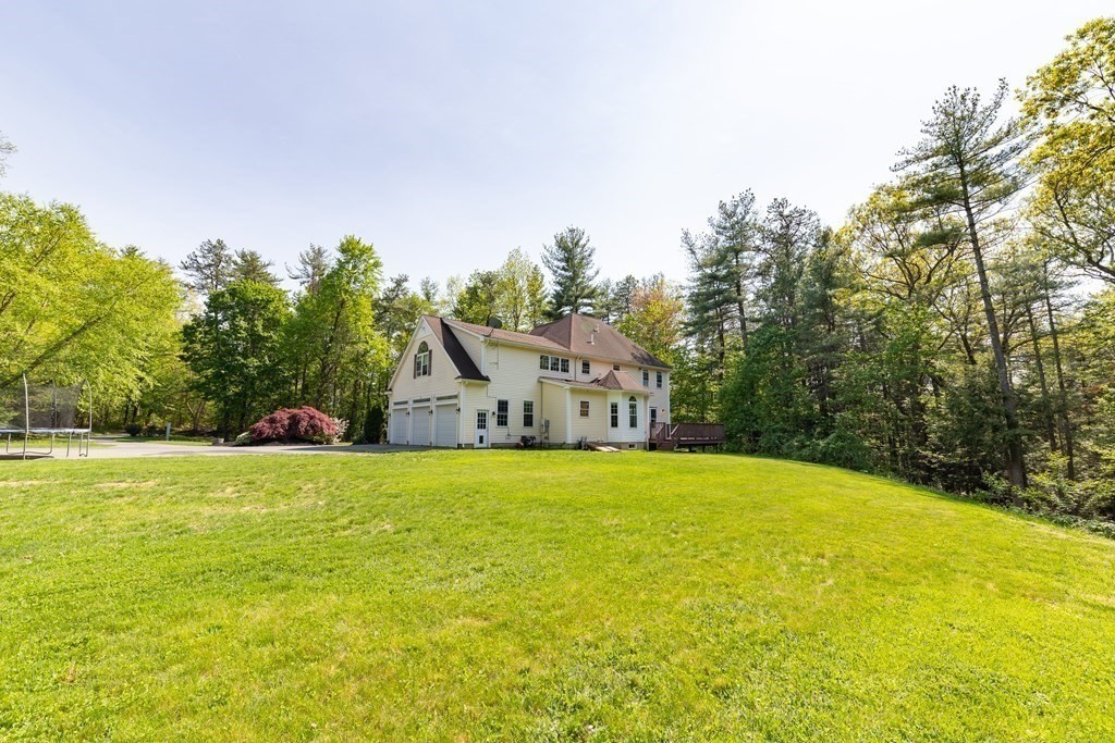 101 Stonefence Road Lunenburg, MA 01462 - Photo 11 of 41 a front view of a house with a big yard