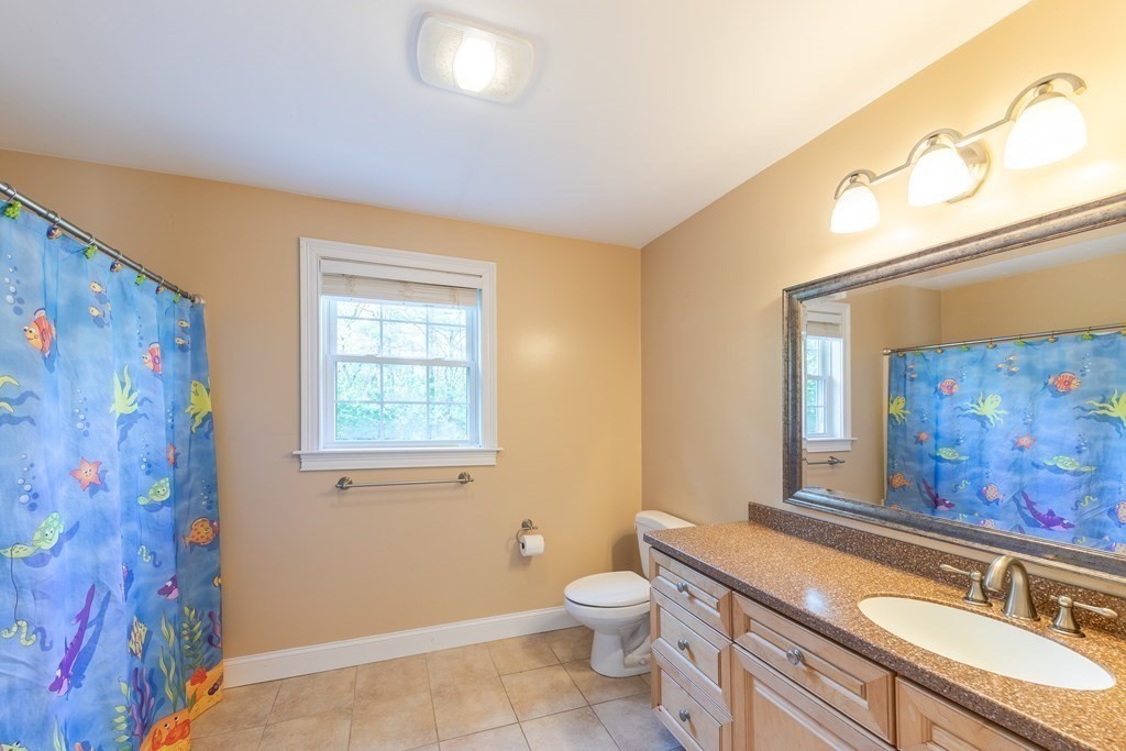 101 Stonefence Road Lunenburg, MA 01462 - Photo 33 of 41 a bathroom with a granite countertop toilet sink and mirror