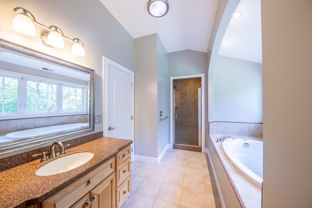 101 Stonefence Road Lunenburg, MA 01462 - Photo 38 of 41 a bathroom with a granite countertop tub sink and mirror
