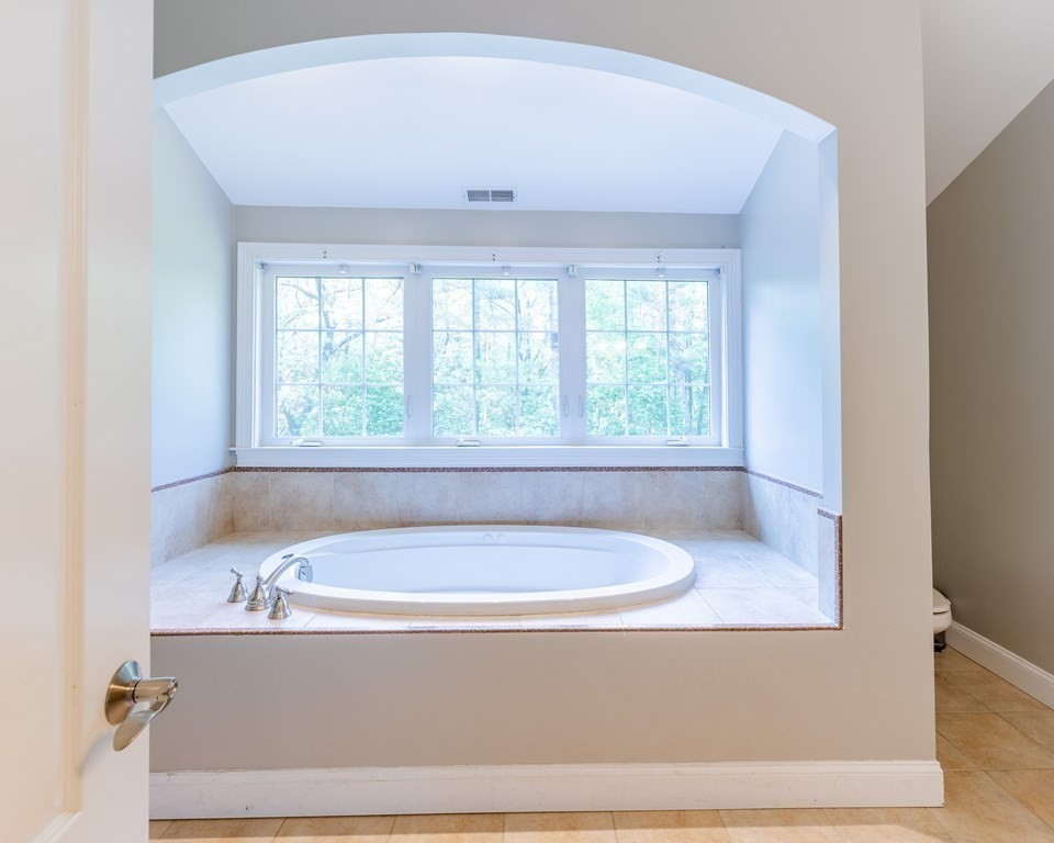 101 Stonefence Road Lunenburg, MA 01462 - Photo 39 of 41 a bathroom with a bathtub and window