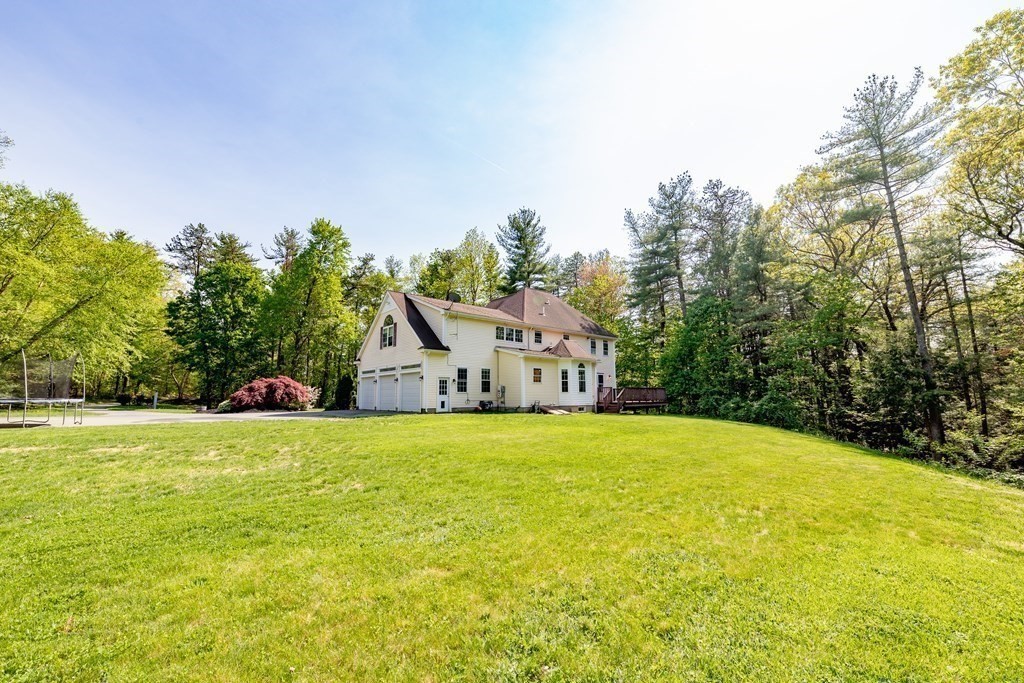 101 Stonefence Road Lunenburg, MA 01462 - Photo 9 of 41 a front view of a house with a yard and trees