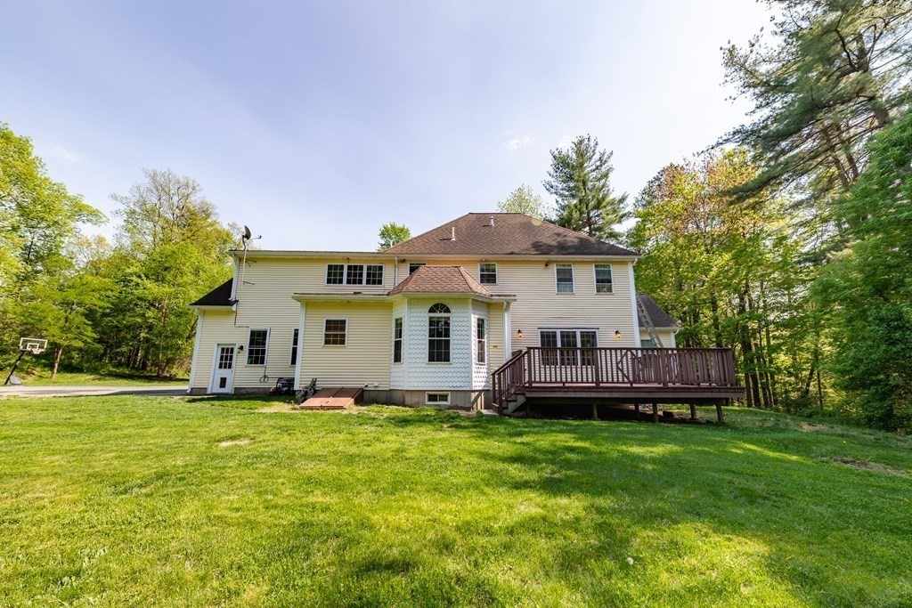 101 Stonefence Road Lunenburg, MA 01462 - Photo 10 of 41 a front view of a house with a garden and trees