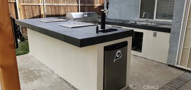 a view of kitchen island with sink