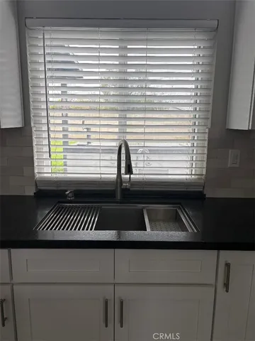a kitchen with a sink and a window