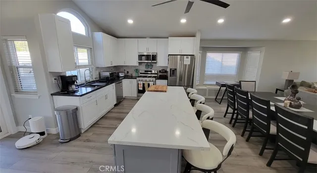 a large kitchen with lots of counter space a sink a window and appliances