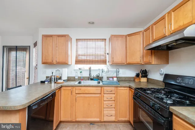 a kitchen with stainless steel appliances granite countertop a sink stove cabinets and a refrigerator