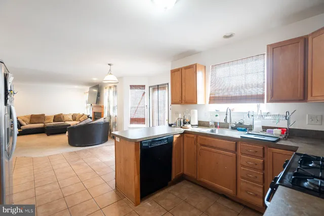 a kitchen with a sink a counter top space and cabinets