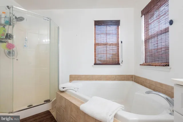 a bath tub sitting next to a window