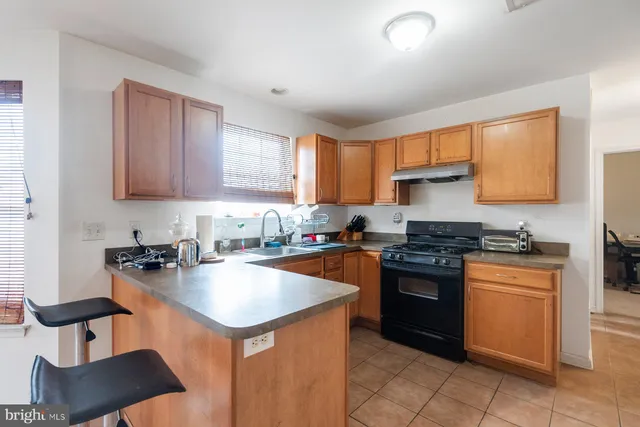 a kitchen with stainless steel appliances granite countertop a stove a sink dishwasher and a refrigerator