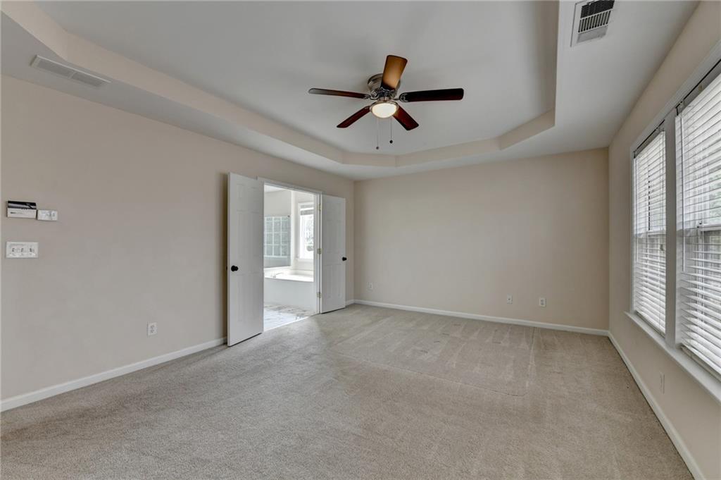 100 Hawnley Trc Northwest Suwanee, GA 30024 - Photo 40 of 58 a view of room with a ceiling fan and window