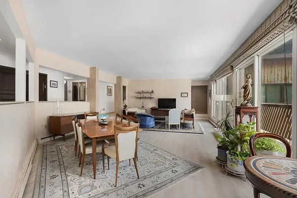 a living room with furniture potted plant and a window