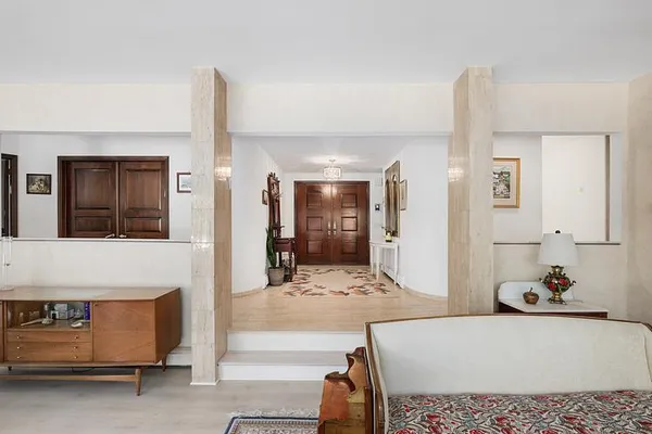 a bedroom with a bed and a large mirror