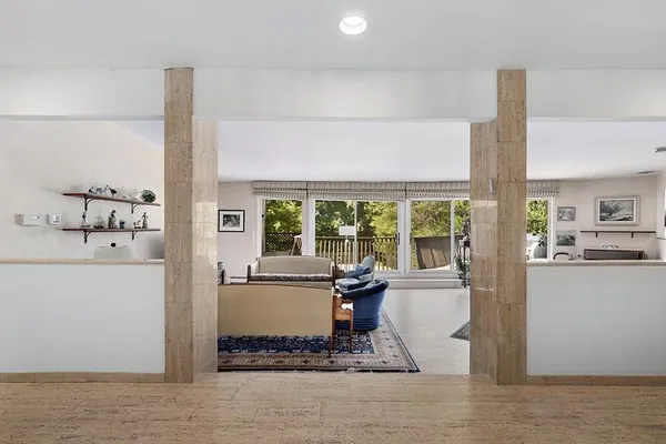 a living room with furniture and large windows